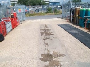 Impact damaged concrete from unloading gas cylinders